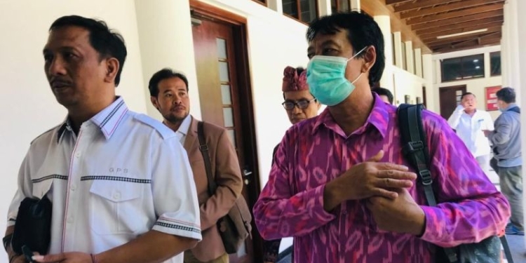 Rektor Universitas Udayana Bali Prof. I Nyoman Gde Antara (kanan) didampingi oleh kuasa hukumnya Gede Pasek Suardika berjalan keluar dari ruangan penyidik Kejaksaan Tinggi Bali, Denpasar, Kamis (6/4/2023). (Foto: Antara/Rolandus Nampu)