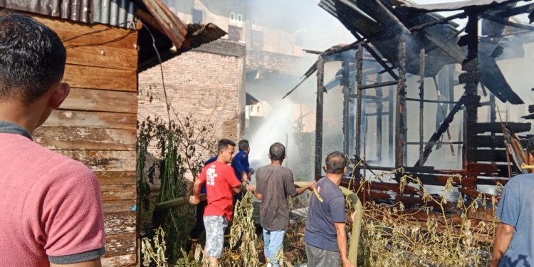 Petugas dan warga memadamkan api yang membakar rumah kosong di Desa Geulumpang Payong, Kecamatan Blangpidie, Abdya. (Foto: Alibi/Dok. BPBA)