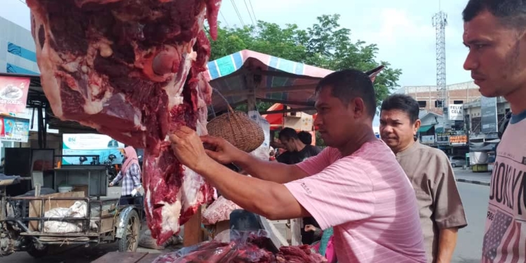 Pedagang daging di Pasar Darussalam, Banda Aceh sedang melayani pembeli. (Foto: Alibi/Fahzian Aldevan)