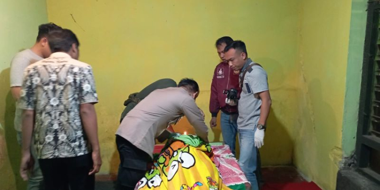 Polisi memeriksa jenazah korban yang ditemukan meninggal dunia di depan kamar mandi rumah kekasihnya di Pare, Kabupaten Kediri, Jawa Timur. (Foto: Dok. Antara/HO-polisi)