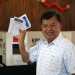 Mantan Wapres Muhammad Jusuf Kalla menunjukan surat suara saat menggunakan hak pilihnya pada Pemilu 2024 di TPS 03 Kelurahan Pulo, Kebayoran Baru, Jakarta, Rabu (14/2/2024). (Foto: Dok. Antara/Muhammad Iqbal)